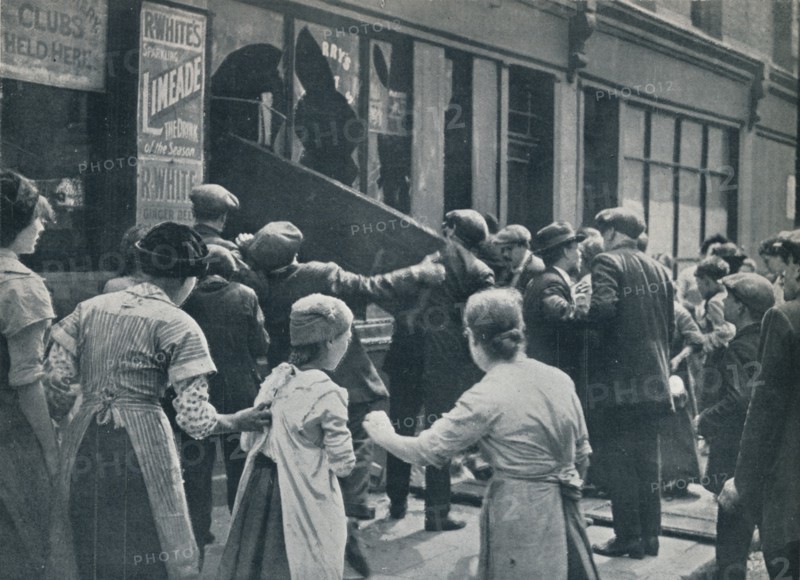 Anti-German rioting in London: A crowd breaking in the windows of a German shop', c1914. Artist: Unknown
