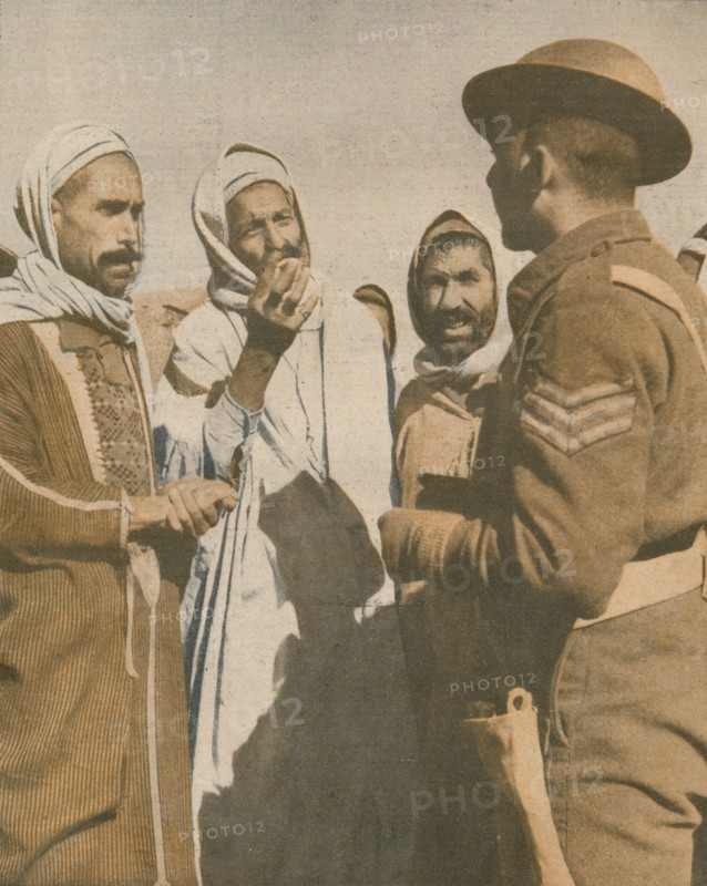 'Tunisian Arabs Welcome a British Sergeant at Chaouach', 1943. Artist: Unknown.