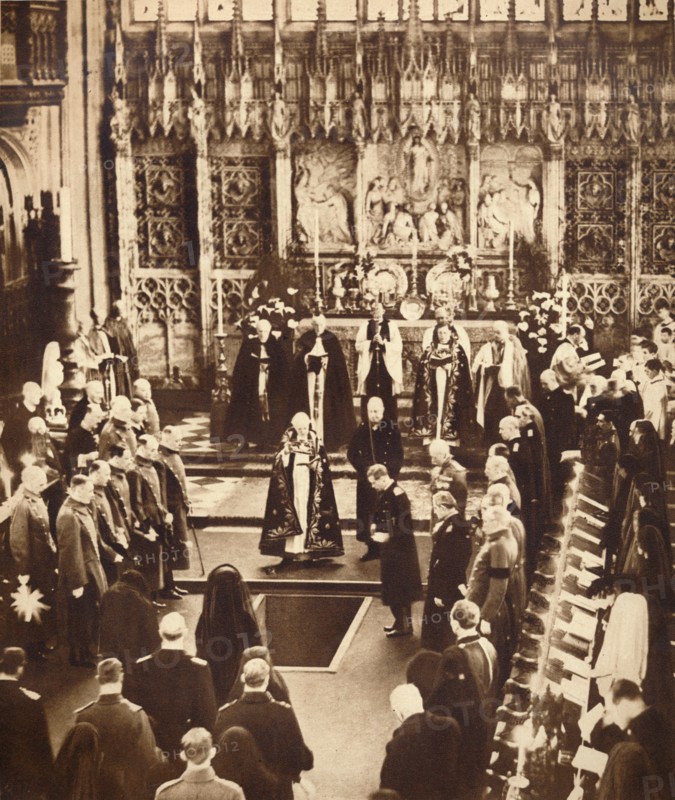 King Edward VIII sprinkles earth on his father's coffin, 1936.  Artist: Unknown.