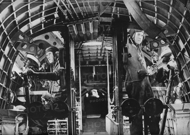 The midship gunners of an RAF flying boat alert at their stations, c1940 (1943). Artist: Unknown.