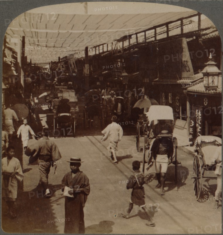 'Mid-summer traffic under awnings of Shiro-bashidori, a busy thoroughfare of Kyoto, Japan', 1904.  Artist: Unknown.
