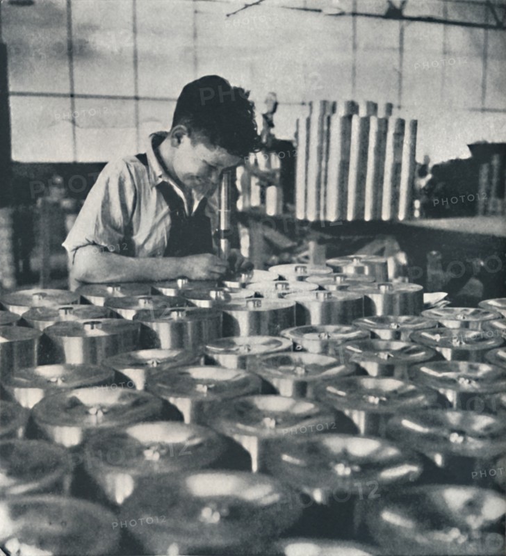 'Apprentice with microscope (testing the hardness of pistons)', 1941. Artist: Cecil Beaton.