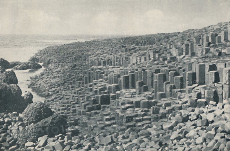 'Tessellated Promenade of the Grand Causeway Laid Down in Lava in the Far Distant Past', c1935. Artists: Unknown, W Lawrence.