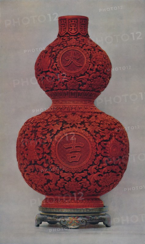 'Vase of Carved Red Lacquer on Olive Green Ground with Stand of Flat Lacquer', 1928. Artist: Unknown.