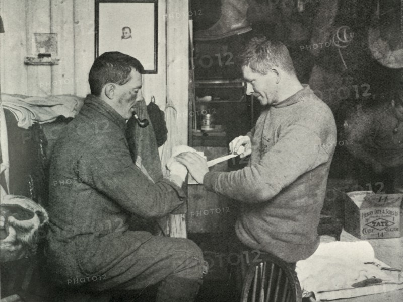 'Petty Officer Evans Binding Up Dr. Atkinson's Hand', 5 July 1911, (1913). Artist: Herbert Ponting.