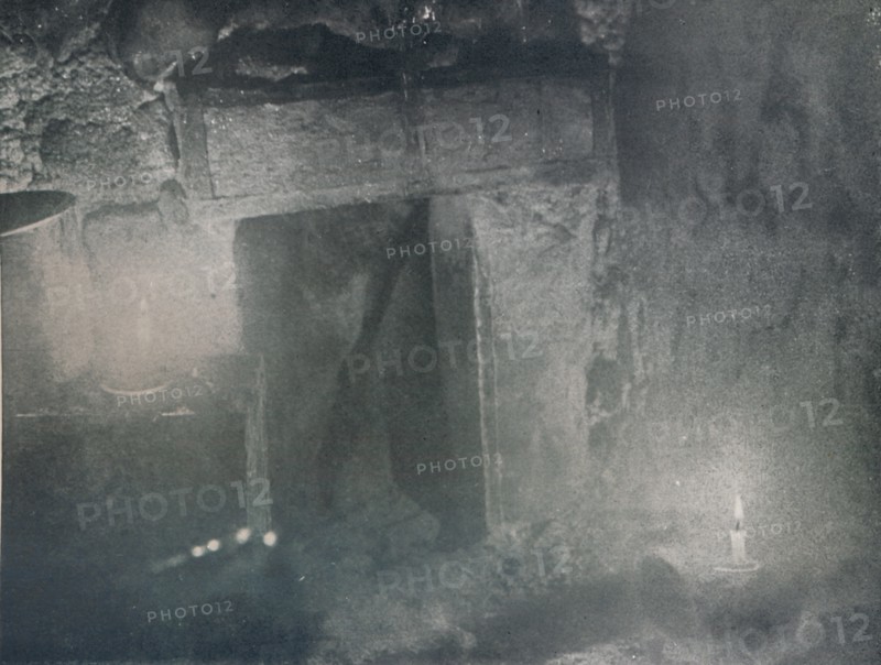 'Inside Door of Igloo by Light of Blubber Lamps', c1911, (1913). Artist: G Murray Levick.