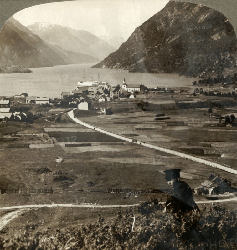 'Village roofs and sunny fields of Odde, N. up the narrow mountain-walled Sorfjord, Norway', 1905. Creator: Unknown.