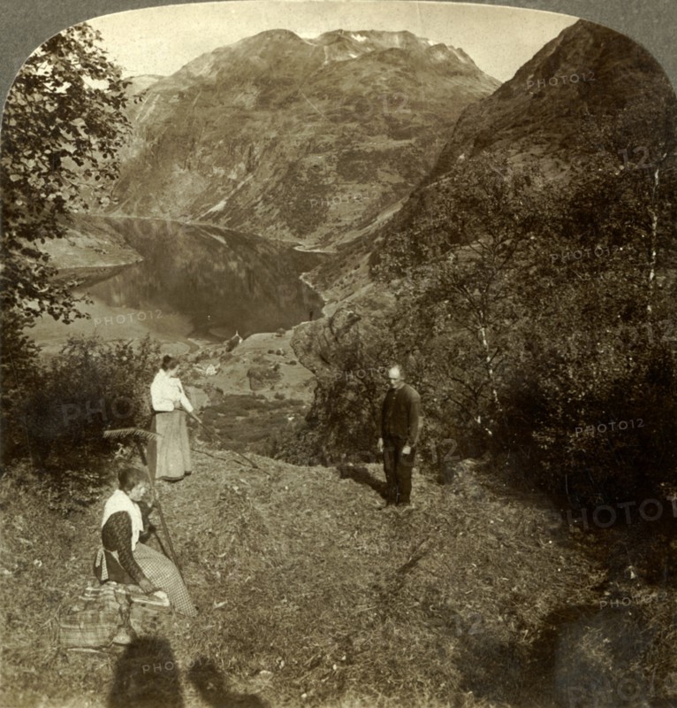 'Haying on mountain shelf high above Marok village and mirror-clear Geirangerfjord, Norway', c1905 Creator: Unknown.