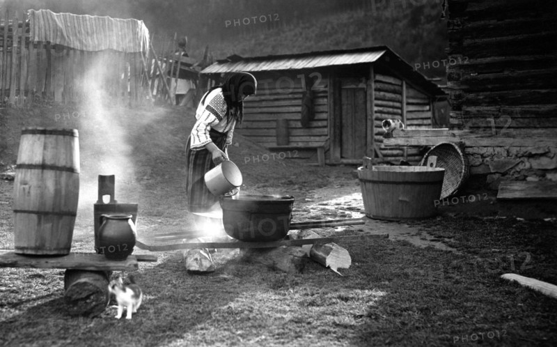 Woman pouring water into a pot, Bistrita Valley, Moldavia, north-east Romania, c1920-c1945. Artist: Adolph Chevalier