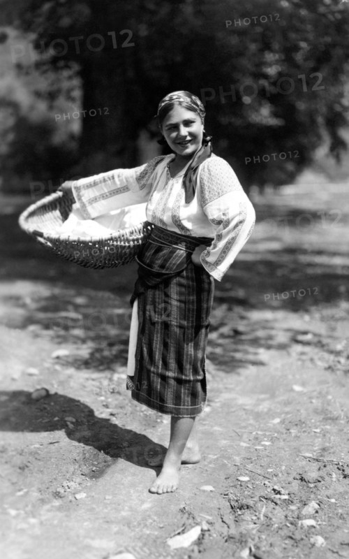 Woman carrying a large basket, Bistrita Valley, Moldavia, north-east Romania, c1920-c1945. Artist: Adolph Chevalier