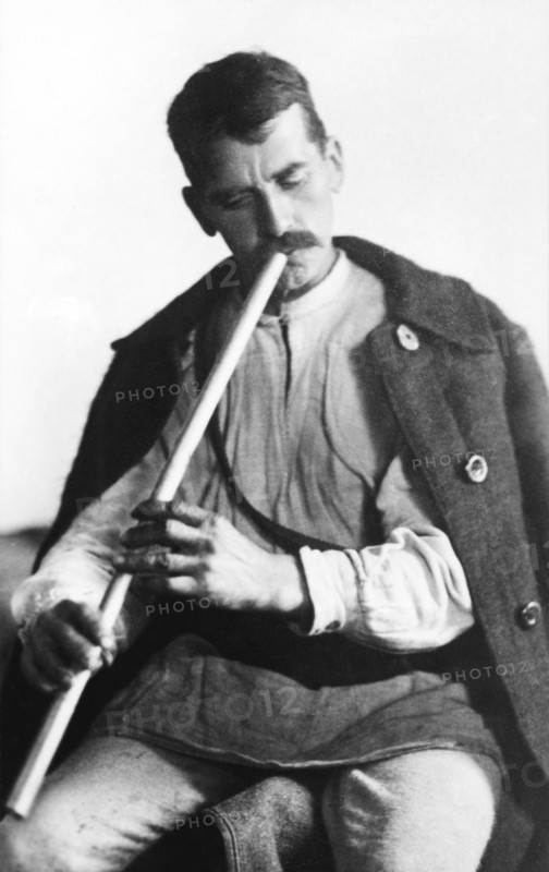 Man playing a wind instrument, Bistrita Valley, Moldavia, north-east Romania, c1920-c1945. Artist: Adolph Chevalier