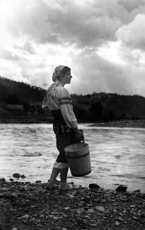 Young woman with a bucket, Bistrita Valley, Moldavia, north-east Romania, c1920-c1945. Artist: Adolph Chevalier