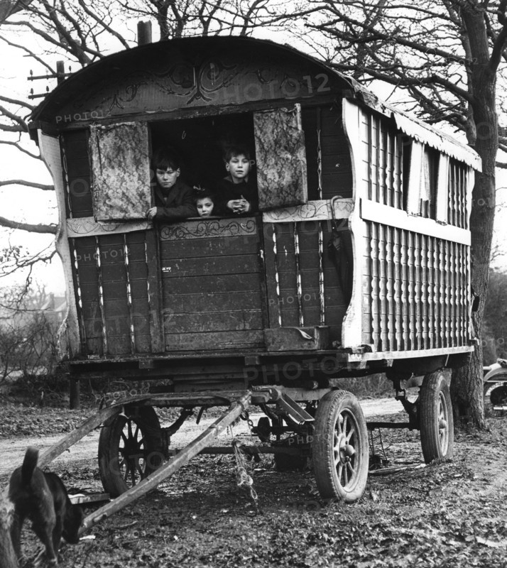 Gipsy children looking out of their caravan by the roadside, Charlwood, Surrey, 1964.