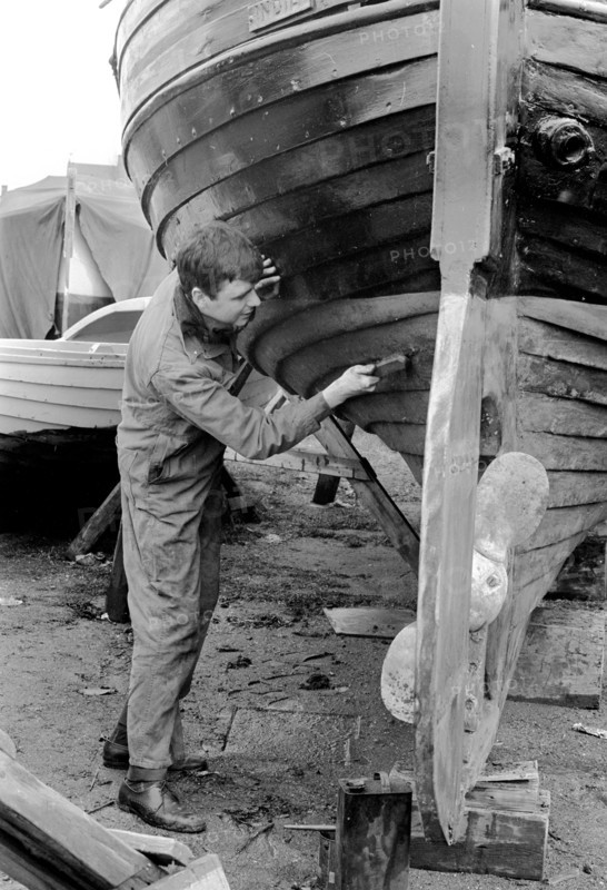 A man cleaning the keel of his sailing boat, Sweden, 1966. Artist: Unknown