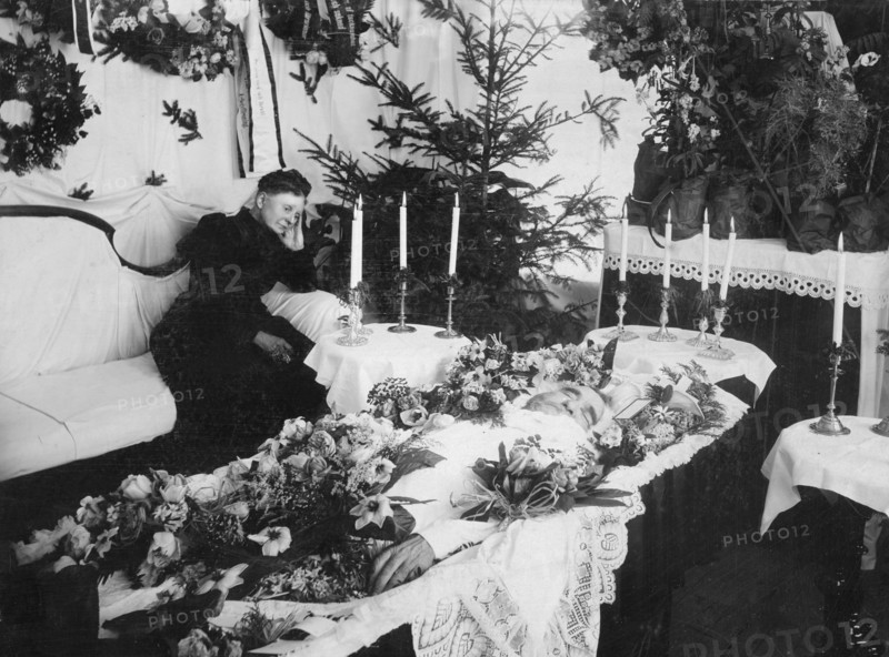A widow grieving for her husband at a wake, Sweden. Artist: Unknown
