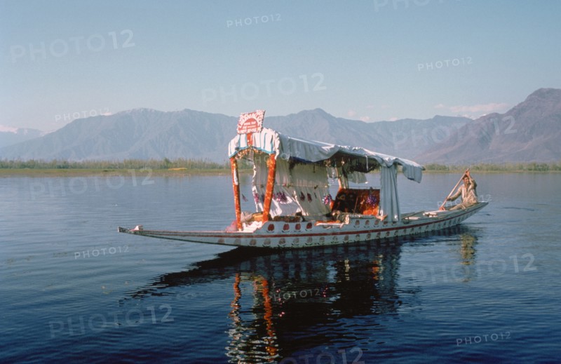 Shikara (traditional wooden boat) on Dal Lake, Srinagar, Kashmir, India.