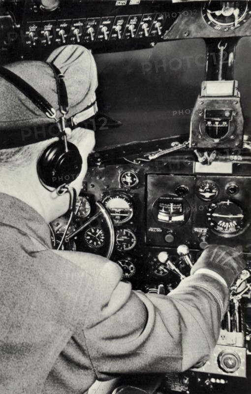 Pilot in the cockpit of a Douglas DC-3 aeroplane, 1940. Artist: Unknown
