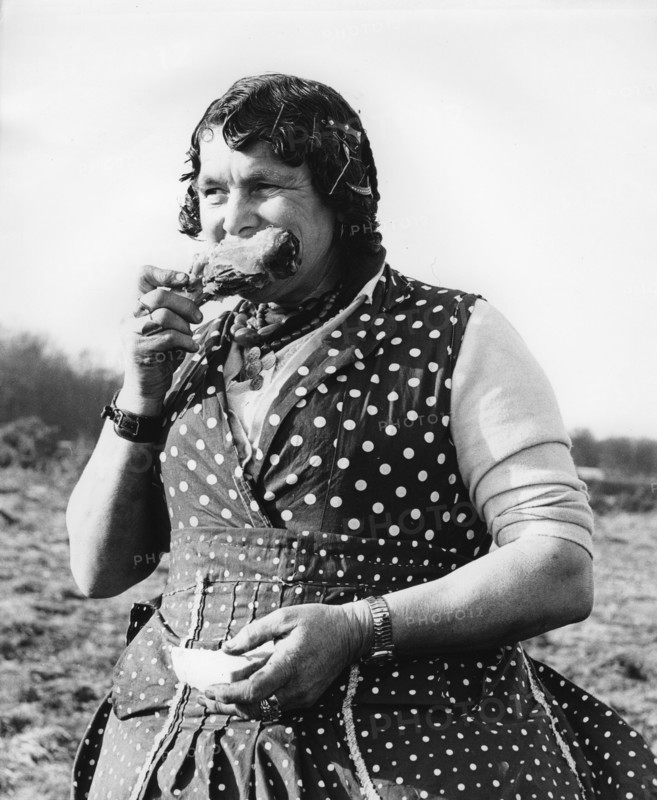 Gypsy woman eating, 1960s.
