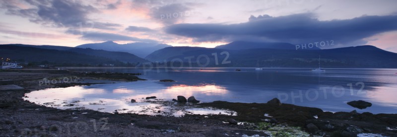 View across Brodick Bay to Beinn Tarsuinn and Goatfell at sunset, Arran, North Ayrshire, Scotland.