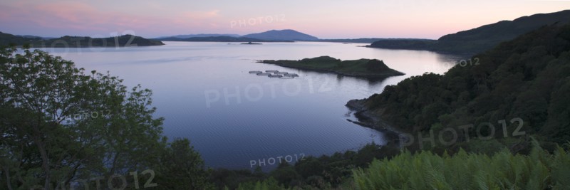 View over Seil Sound to a salmon farm and Luing, Slate Islands, Argyll and Bute, Scotland.