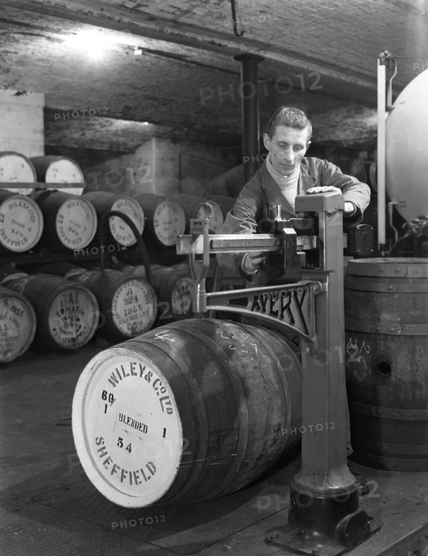 Weighing barrels of blended whisky at Wiley & Co, Sheffield, South Yorkshire, 1960. Artist: Michael Walters