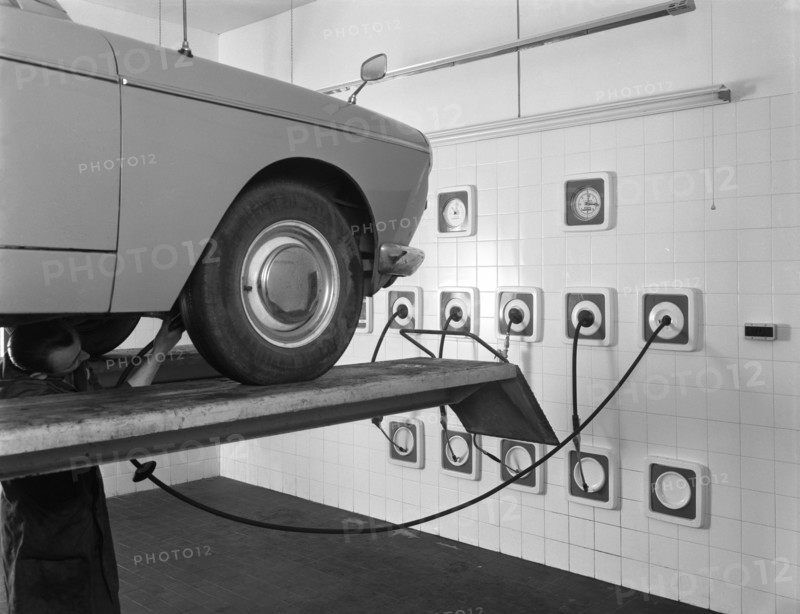 A traditional lubrication bay and mechanic at a garage, Sheffield, South Yorkshire, 1965. Artist: Michael Walters