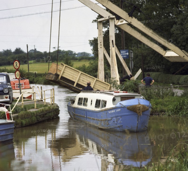 A canal boat passing under a lift bridge on the Llangollen Canal, 1970. Artist: Michael Walters