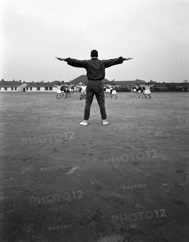 Games master taking a gym class, Airedale school, Castleford, West Yorkshire, 1962. Artist: Michael Walters