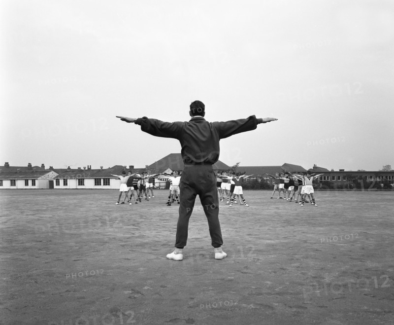 Games master taking a gym class, Airedale school, Castleford, West Yorkshire, 1962. Artist: Michael Walters