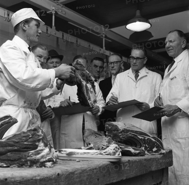 Apprentice butcher showing his work to competition judges, Barnsley, South Yorkshire, 1963. Artist: Michael Walters