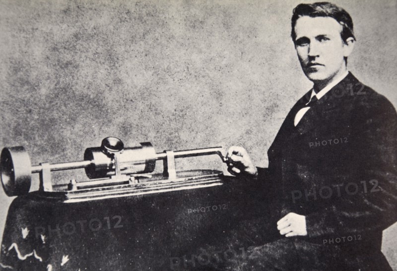 Thomas Alva Edison sitting beside his invention, the phonograph, 1878. Artist: Unknown