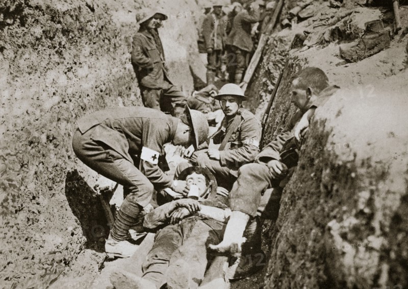 Red Cross men in the trenches tend a wounded man, Somme campaign, France, World War I, 1916. Artist: Unknown