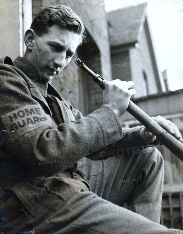 British Home Guard soldier cleaning his rifle, World War II, c1940-c1944. Artist: Unknown