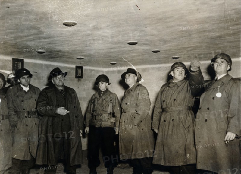 American soldiers examine a gas chamber, Dachau concentration camp, Bavaria, Germany, c1945. Artist: Unknown