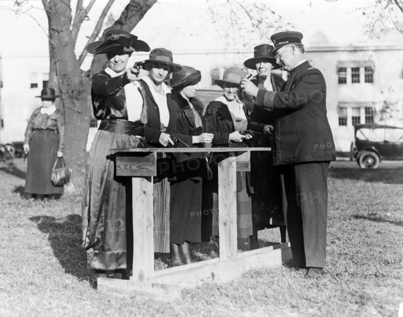 Police officer teaching women how to shoot, c. 1920.