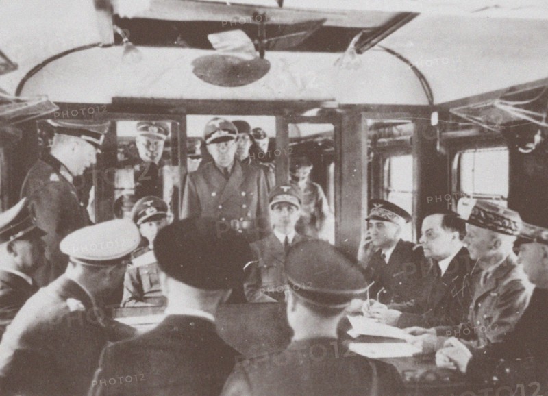 The German and French delegations inside a railroad car at Compiègne for the signing of France's sur Artist: Anonymous