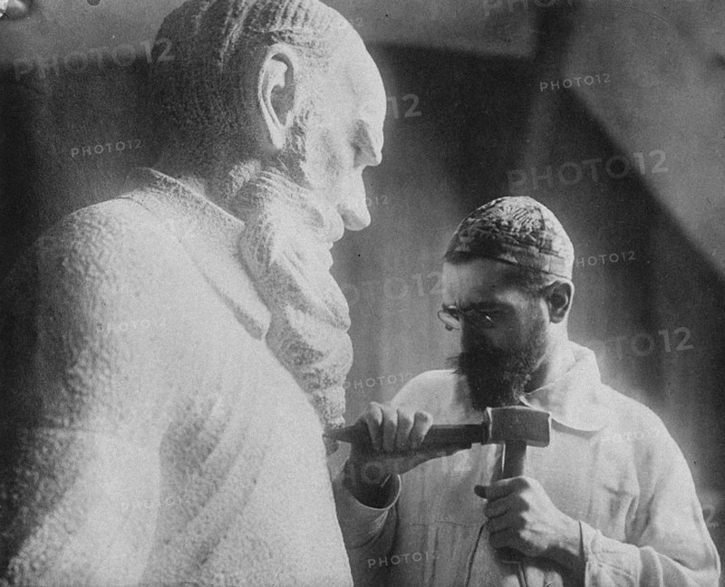 Russian sculptor Sergey Merkurov (1881-1952) working on his statue of Leo Tolstoy Artist: Anonymous
