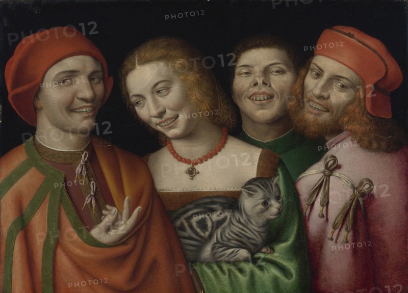 Three men with a woman holding a cat.