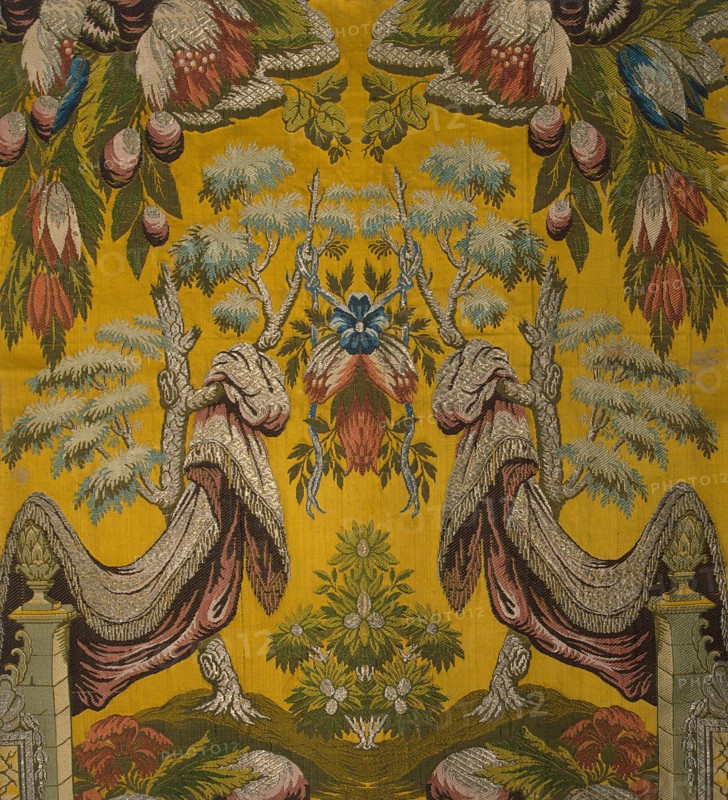 Silk fabric with silver thread, satin ground with a brocaded pattern.
