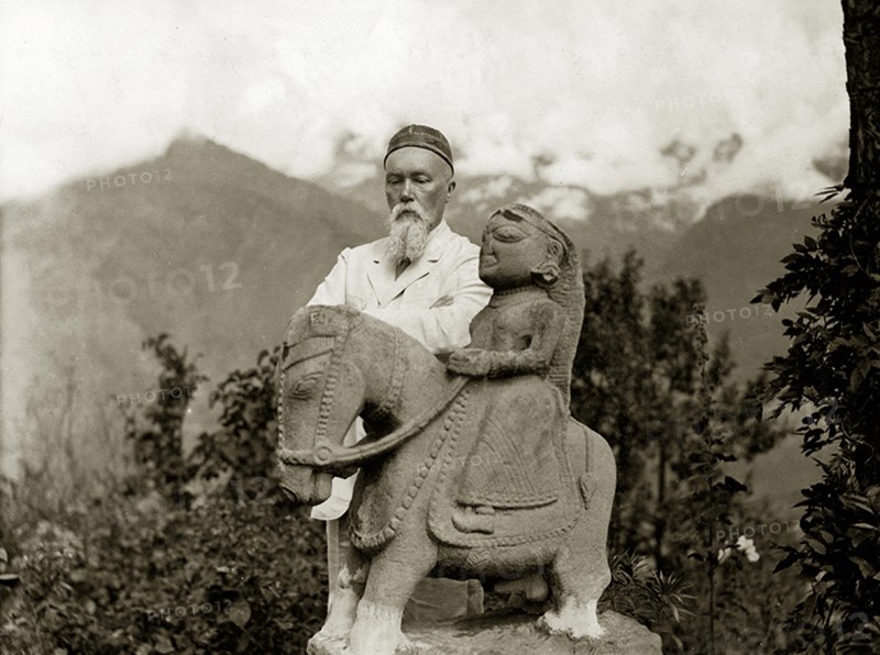 Nicholas Roerich by the equestrian statue of Guga Chauhan at the Kullu Valley, 1932-1933.