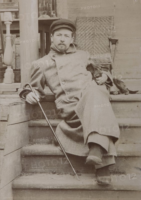 Anton Chekhov (1860-1904) with dog Hina. Melikhovo, 1897.