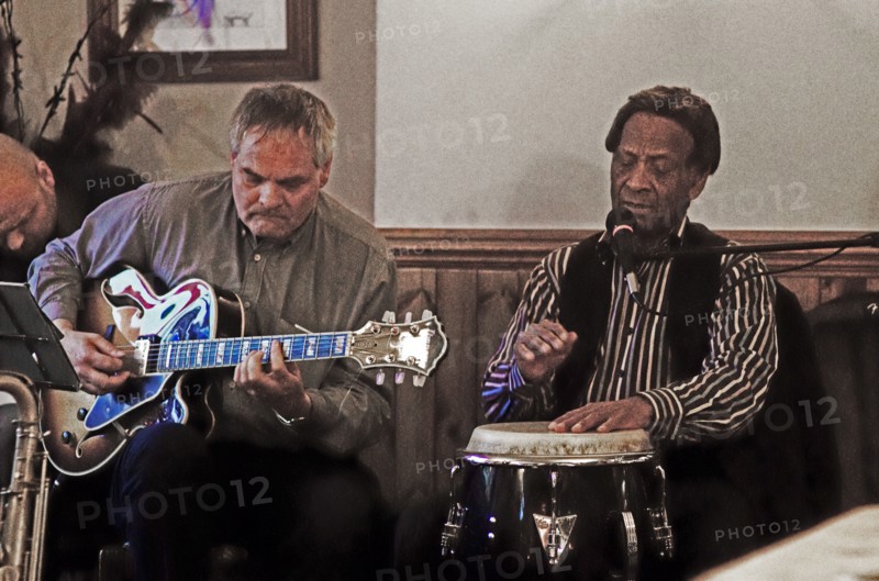 Frank Holder, Guyanan jazz singer and percussionist with Shane Hill, The Castle, Outwood, Surrey.    Artist: Brian O'Connor