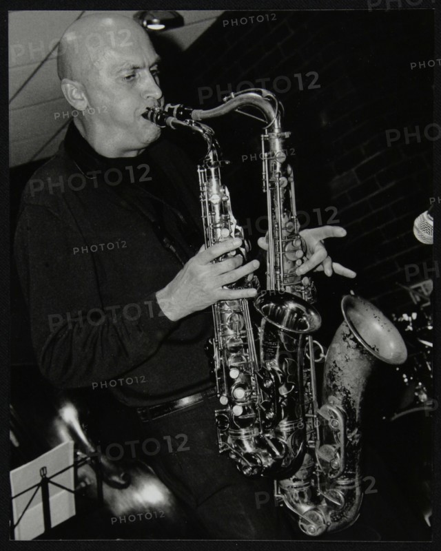 Kelvin Christiane playing two saxophones at The Fairway, Welwyn Garden City, Hertfordshire, 2002. Artist: Denis Williams