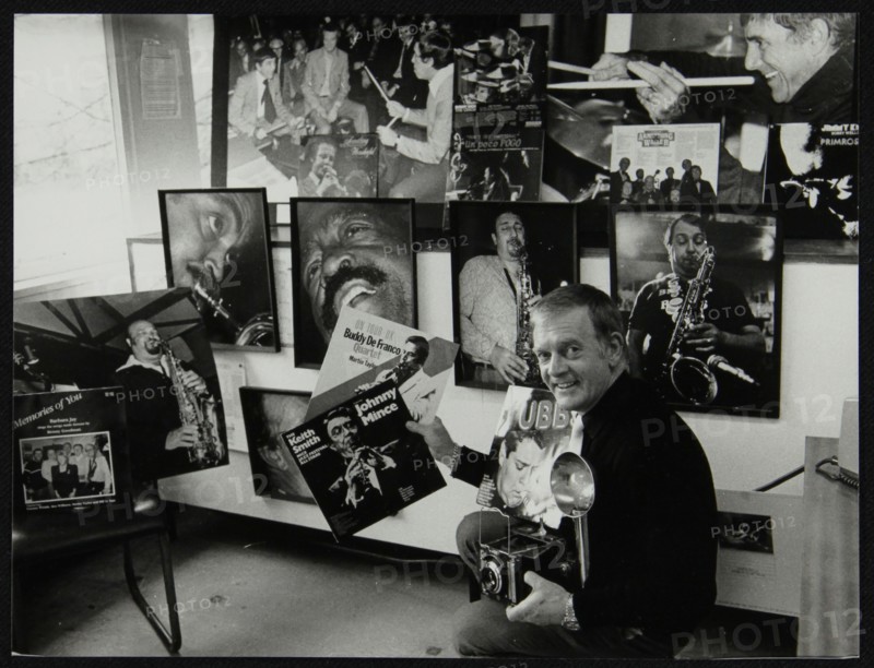 Photographer Denis Williams holding an LP cover. Artist: Unknown