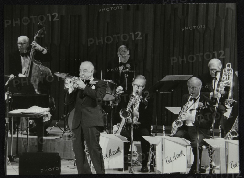 The Ted Heath Orchestra in concert, London 1985. Pictured are Lennie Bush (double bass), Kenny Baker Artist: Denis Williams