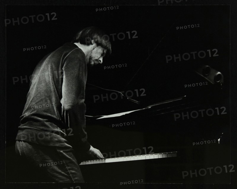 Michael Garrick on the piano at The Stables, Wavendon, Buckinghamshire. Artist: Denis Williams