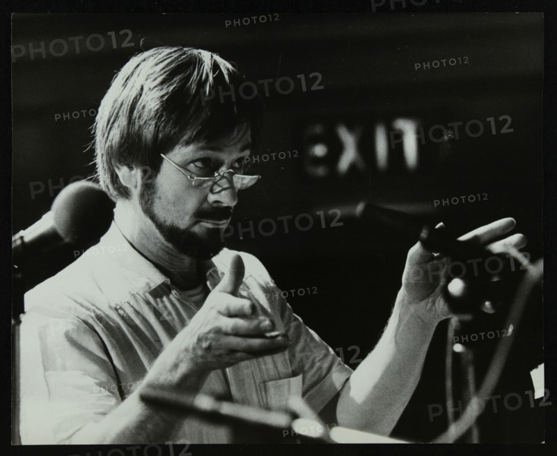 Michael Garrick conducting an orchestra at Berkhamsted Civic Centre, 1985. Artist: Denis Williams