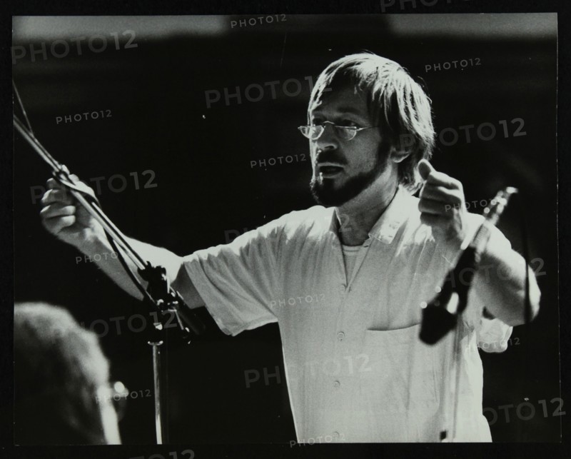 Michael Garrick conducting an orchestra at Berkhamsted Civic Centre, 1985. Artist: Denis Williams