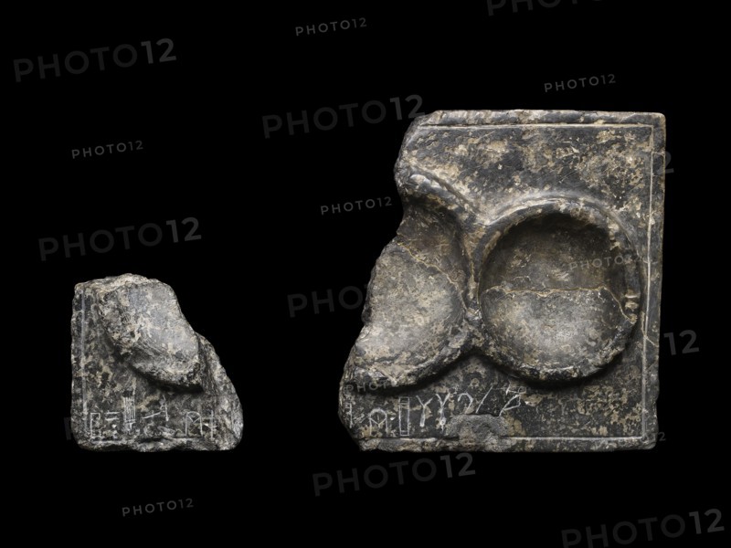 Libation table fragment; corner and part of two circular receptacles, c2325-c2175BC.. Artist: Unknown.