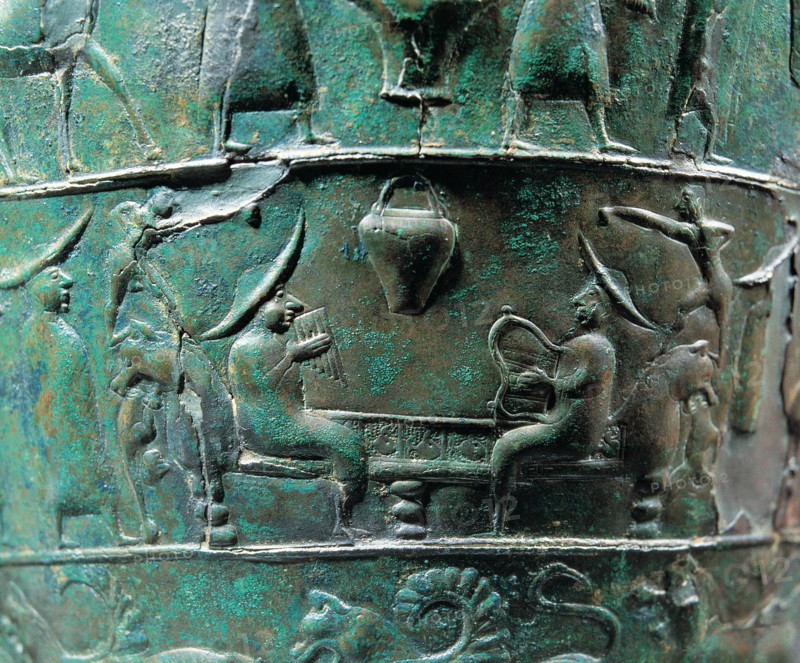 Scene from a situla in bronze of the Certusa of Bologna with a character playing the harp and ano?